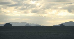 A large body of water with mountains in the background, perfect for those seeking active tours Shikoku and breathtaking natural scenery.